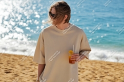 Person holding drink on sandy beach ocean Product Image 1