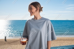 Woman holding drink on beach ocean Product Image 1