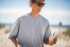 Man wearing grey t shirt holding drink t-shirt beach Product Image 1