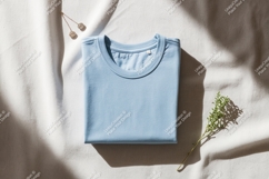 Light blue folded t shirt with earrings and herb image Product Image 1