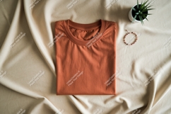 Folded terracotta t shirt with plant and bracelet image Product Image 1