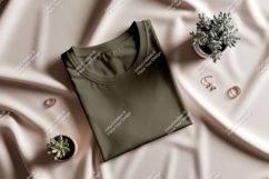 Olive green t shirt mockup with jewelry and plants Product Image 1