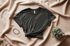 Dark grey t shirt draped on neutral fabric image Product Image 1