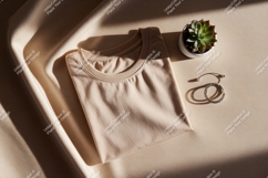 Folded beige t shirt with plant and jewelry image Product Image 1