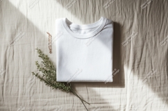 Folded white t shirt with jewelry and greener Product Image 1