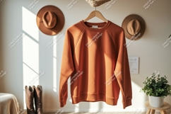 Orange sweatshirt hanging indoors garment clothing Product Image 1