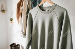 Light green sweatshirt hanging clothing apparel Product Image 1