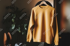 Mustard yellow sweatshirt hanging clothing Product Image 1