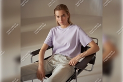 Woman Wearing Lilac Tshirt Mockup In Chair Product Image 1