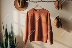 Terracotta sweatshirt hanging with boots and hat image Product Image 1