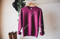 Magenta sweatshirt hanging on rack with boots clothing Product Image 1
