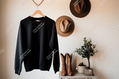 Black sweatshirt hanging with cowboy boots and hats Product Image 1