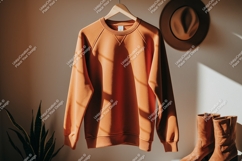 Orange sweatshirt hanging with hat and boots clothing Product Image 1