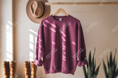 Maroon sweatshirt hanging on rack clothing apparel Product Image 1