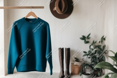 Teal sweatshirt hanging on rack clothing hanger Product Image 1