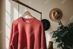Coral sweatshirt hanging on rack hanger clothing Product Image 1