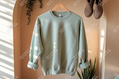 Light green sweatshirt hanging indoors clothing apparel Product Image 1