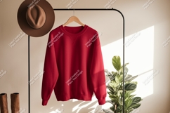 Red sweatshirt hanging on rack with hat and boots clothing Product Image 1