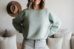 Woman wearing mint green sweatshirt and jeans image Product Image 1