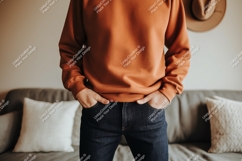 Orange sweatshirt dark jeans hands pockets denim Product Image 1