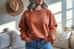 Woman wearing orange sweatshirt and jeans casual Product Image 1