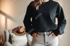 Black sweatshirt light jeans hat chair image Product Image 1