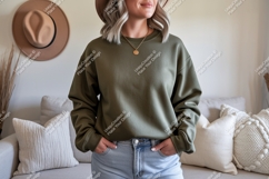 Woman wearing olive green sweatshirt and blue jeans Product Image 1