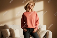 Woman wearing coral sweatshirt and hat denim Product Image 1