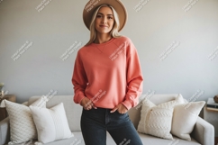 Woman wearing coral sweatshirt and hat denim Product Image 1