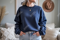 Woman wearing navy blue sweatshirt and jeans image Product Image 1