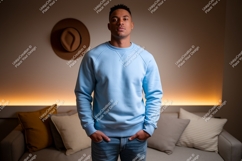 Man wearing blue sweatshirt jeans couch Product Image 1