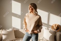 Woman wearing beige sweatshirt and jeans Product Image 1