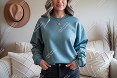 Woman wearing teal sweatshirt and black jeans Product Image 1