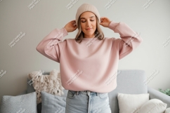 Woman wearing pink sweatshirt and beanie jeans Product Image 1