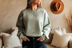 Woman wearing sage green sweatshirt dark jeans denim Product Image 1