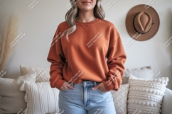 Woman wearing orange sweatshirt and jeans casual Product Image 1