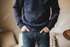 Person wearing dark blue sweatshirt and denim jeans Product Image 1