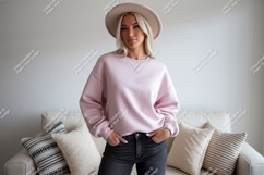 Woman wearing pink sweatshirt and hat denim Product Image 1