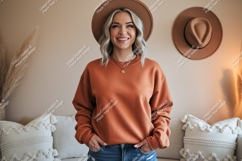 Woman wearing orange sweatshirt and hat denim Product Image 1