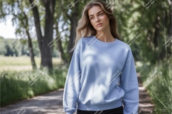 Woman in blue sweatshirt outdoors mockup Product Image 1