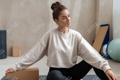 Woman in sweatshirt sitting on mat mockup Product Image 1