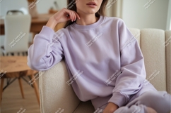 Woman in lilac sweatshirt on couch mockup Product Image 1