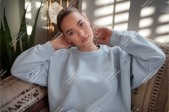 Woman in blue sweatshirt on couch mockup Product Image 1