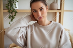 Woman poses indoors wearing sweatshirt mockup Product Image 1