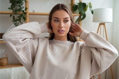 Woman in sweatshirt poses indoors mockup Product Image 1