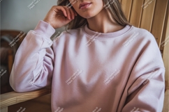 Woman wearing light pink sweatshirt casual comfortable Product Image 1