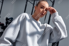 Woman wearing grey sweatshirt in gym Product Image 1