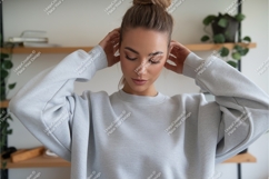 Woman wearing light grey sweatshirt casual fashion Product Image 1