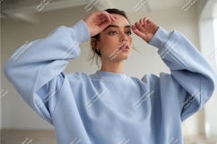 Young woman wearing light blue sweatshirt casual fashion Product Image 1