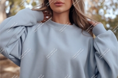 Woman wearing light blue sweatshirt casual clothing Product Image 1